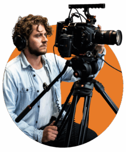 Mann mit Bart und Kopfhörer hinter einer Videokamera